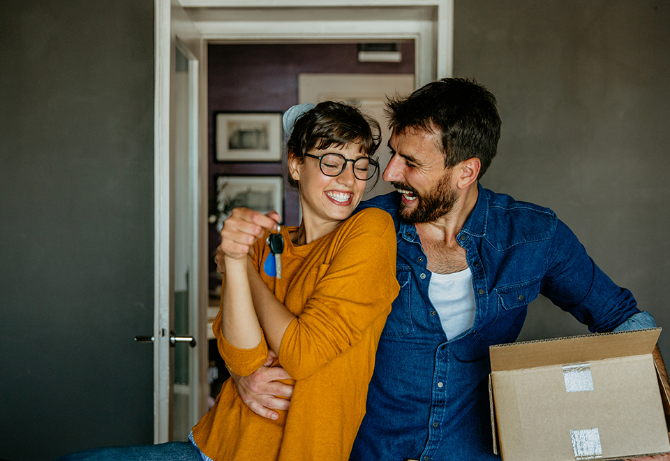 Loan Mortgage Lending Team Calculators - 960x660 – Chemung Canal Trust Company A couple is happily dancing in their kitchen