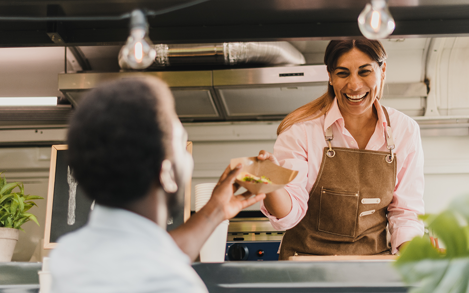 Payment-Processing-960x600 – Chemung Canal Trust Company  A woman in a food truck hands a customer a basket of food