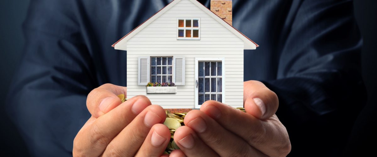 RSshutterstock_207515995-scr Photo of hands outstretched with a model of a home held in them