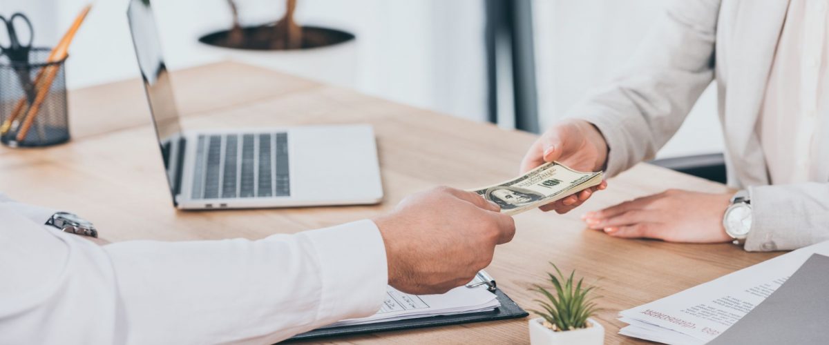 Man holding his hand out with money